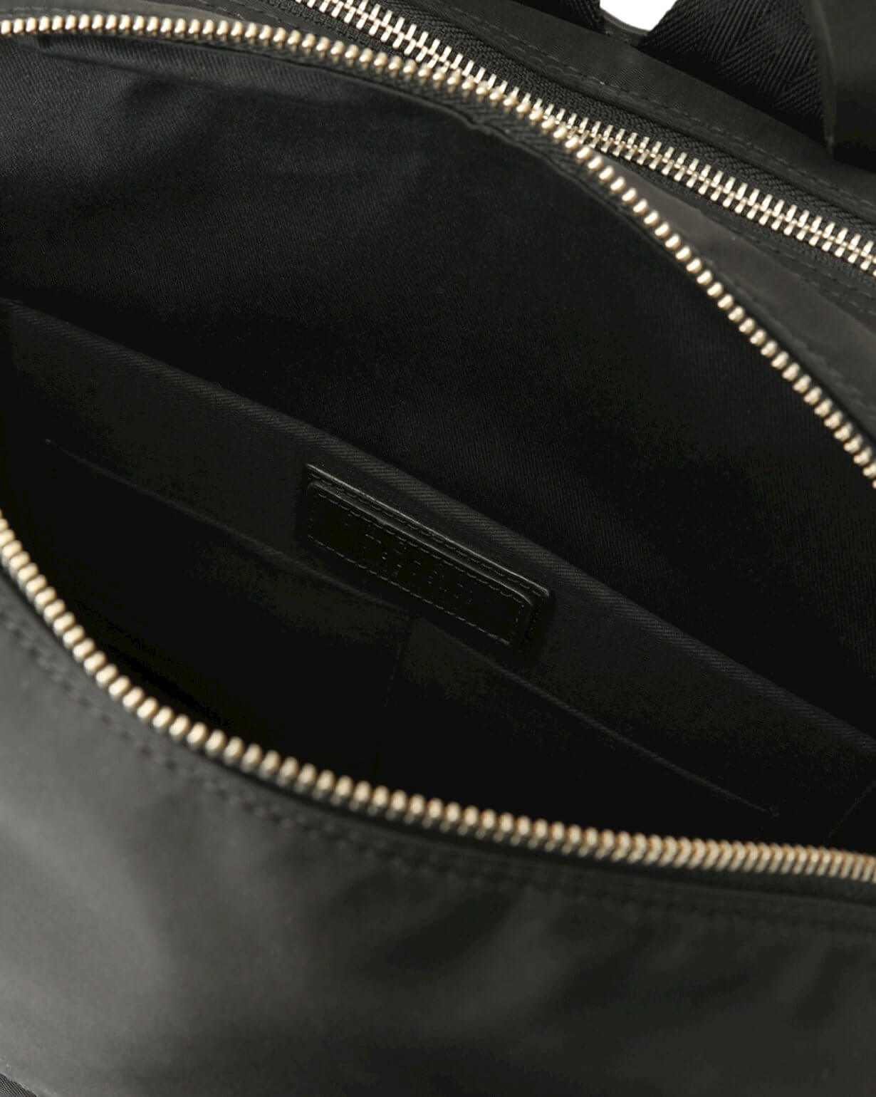 Inside view of Zaino Nobuckle Planet Eco-Logic backpack showcasing eco-nylon lining and zipper details.