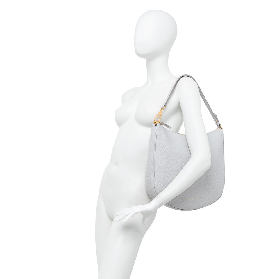 Large gray leather shoulder bag 'Brooke' on a mannequin, featuring a removable strap and stylish design.