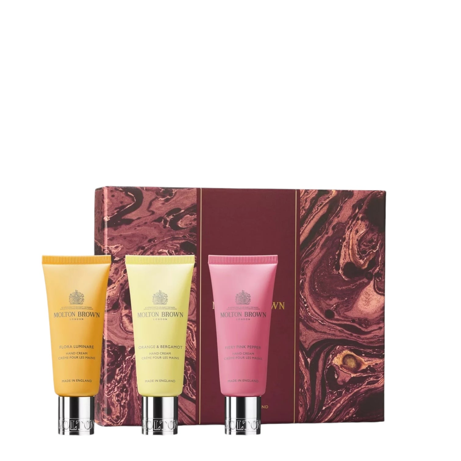 Set Regalo Mani with three hand creams: Flora Luminare, Orange & Bergamot, and Pink Pepper in elegant packaging.