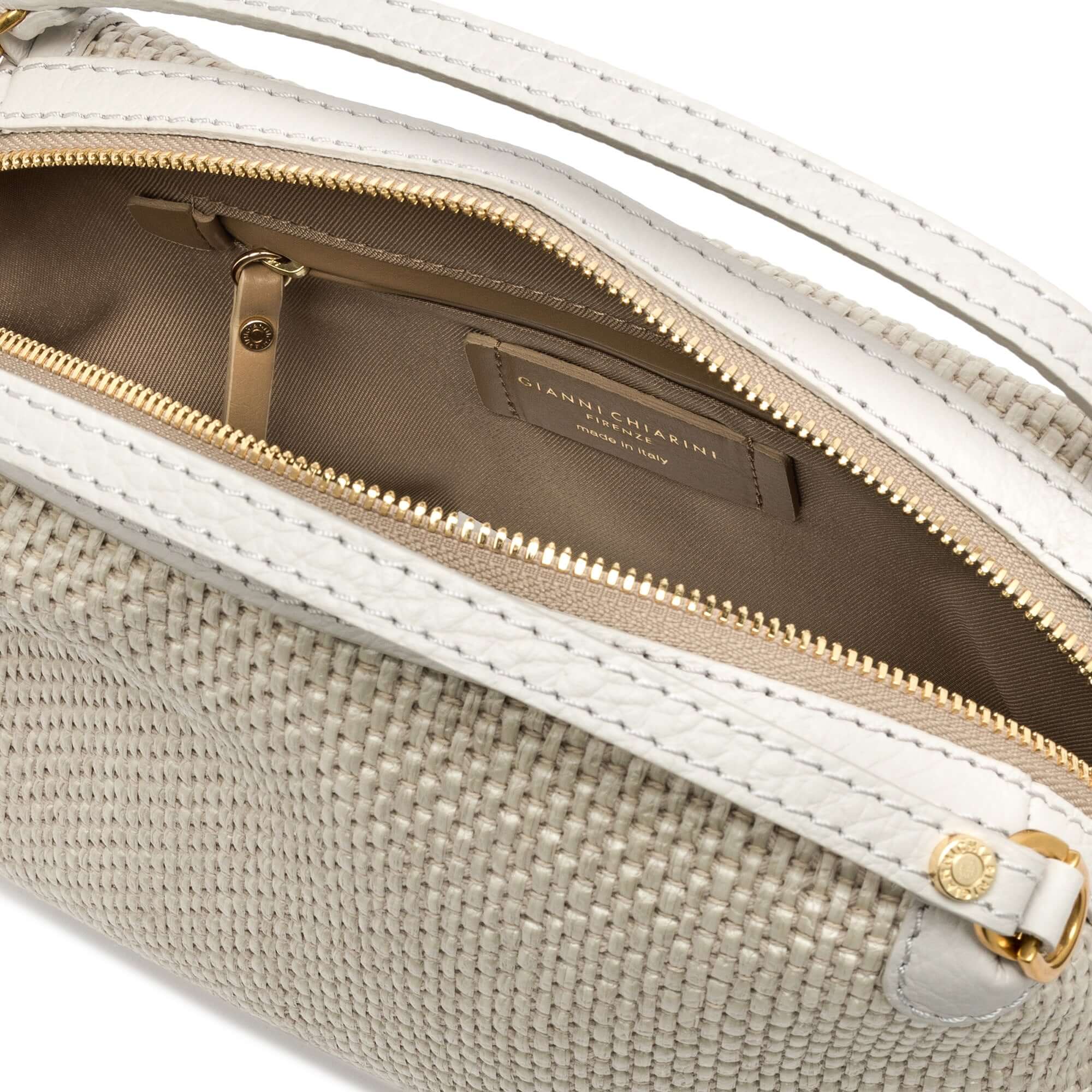 Interior view of Alifa handbag featuring zip closure, woven straw fabric, and leather accents.