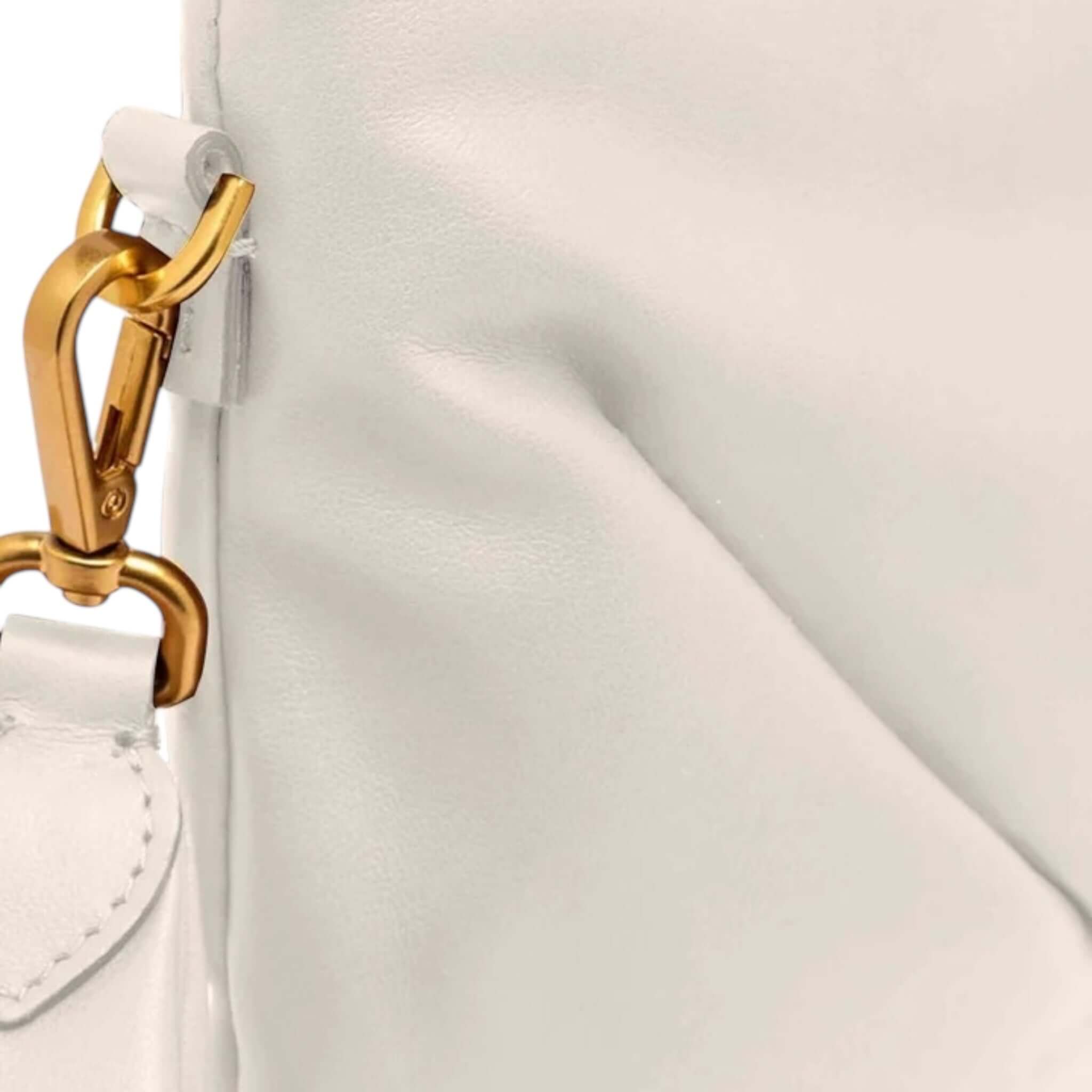 Close-up of Gianni Chiarini Firenze Allegra clutch, showing soft leather and gold chain attachment detail.