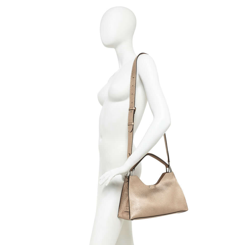 AURORA handbag by Gianni Chiarini, trapezoidal shape, textured leather, adjustable strap, modern elegance.