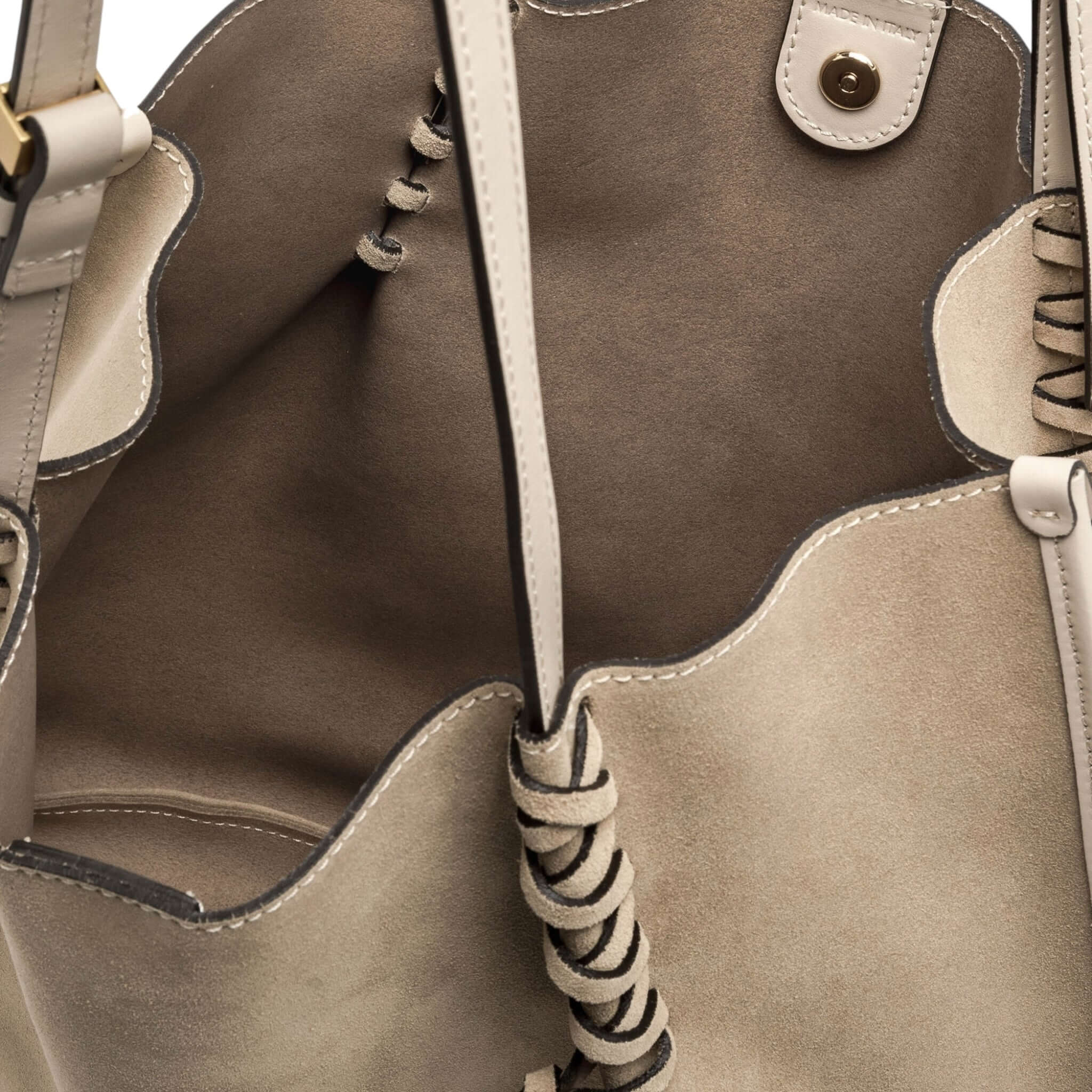 Interior view of Dory handbag, featuring soft suede, unique lacing detail, and spacious design for casual styles.