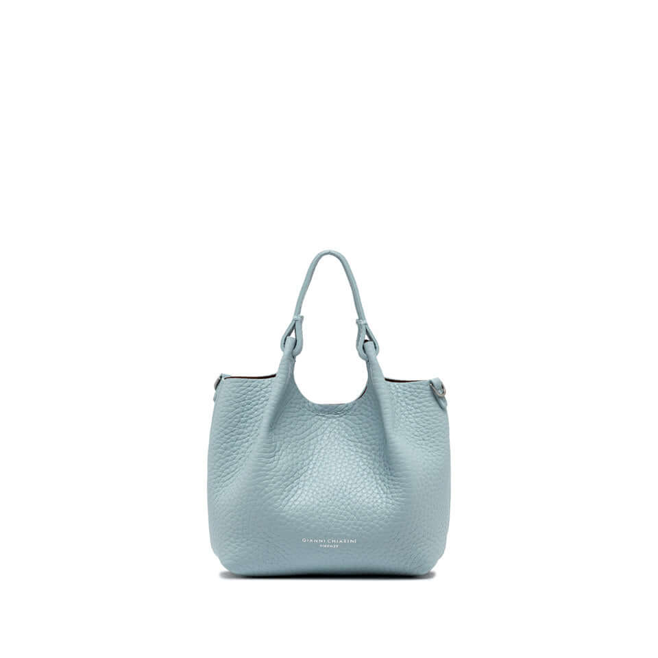 Light blue DUA handbag made of double grain leather, featuring two handles and a magnetic closure.