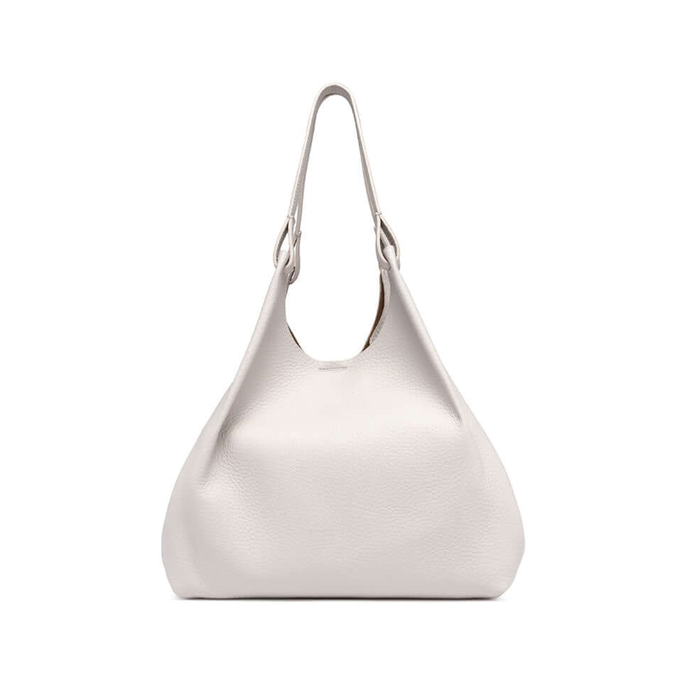 Elegant white DUA handbag made of double-grain leather, featuring dual handles and a magnetic closure.