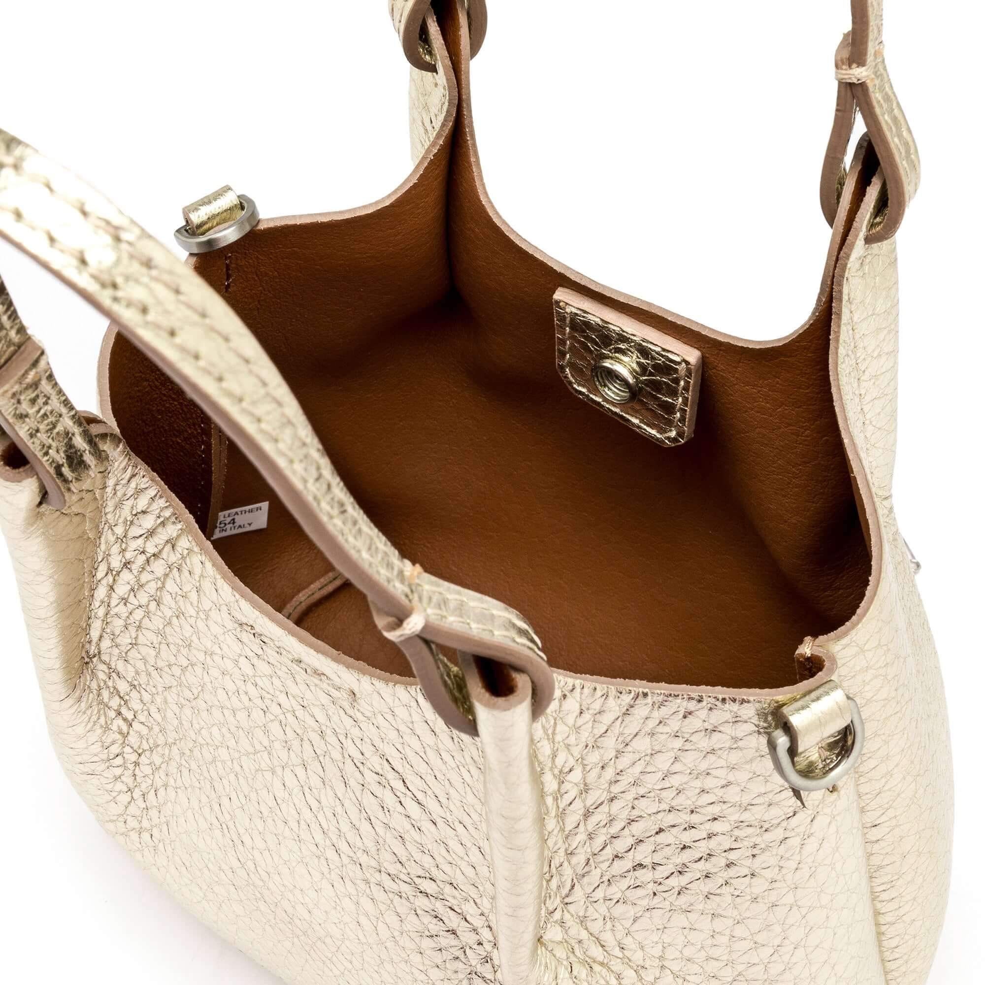 Interior view of the DUA bubble leather bag featuring a spacious unlined compartment and elegant golden accents.