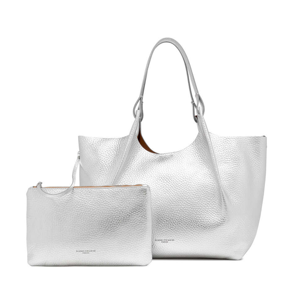 Contemporary DUA handbag set in white leather, featuring a spacious tote and a matching pouch.