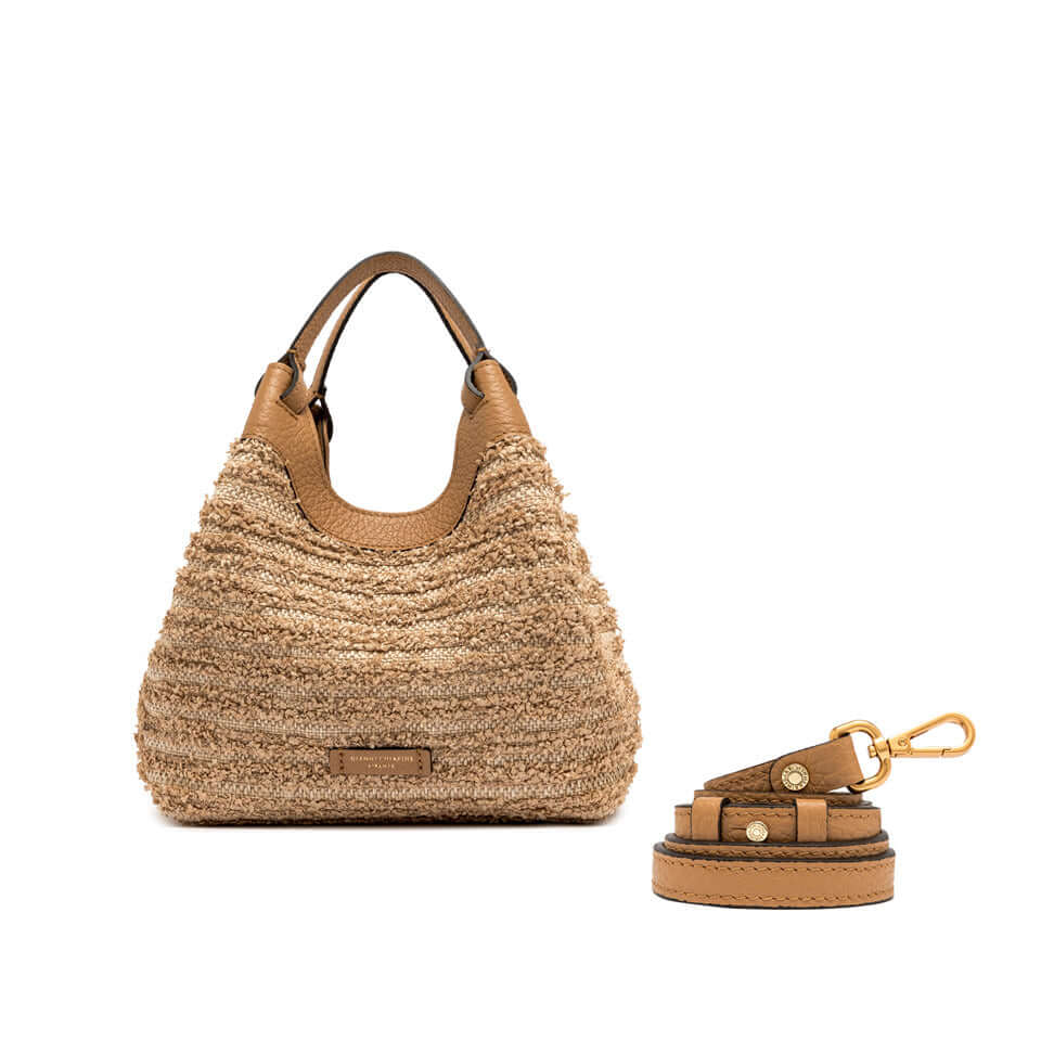 Stylish DUA straw handbag with leather handles and adjustable strap, ideal for versatile carry options.