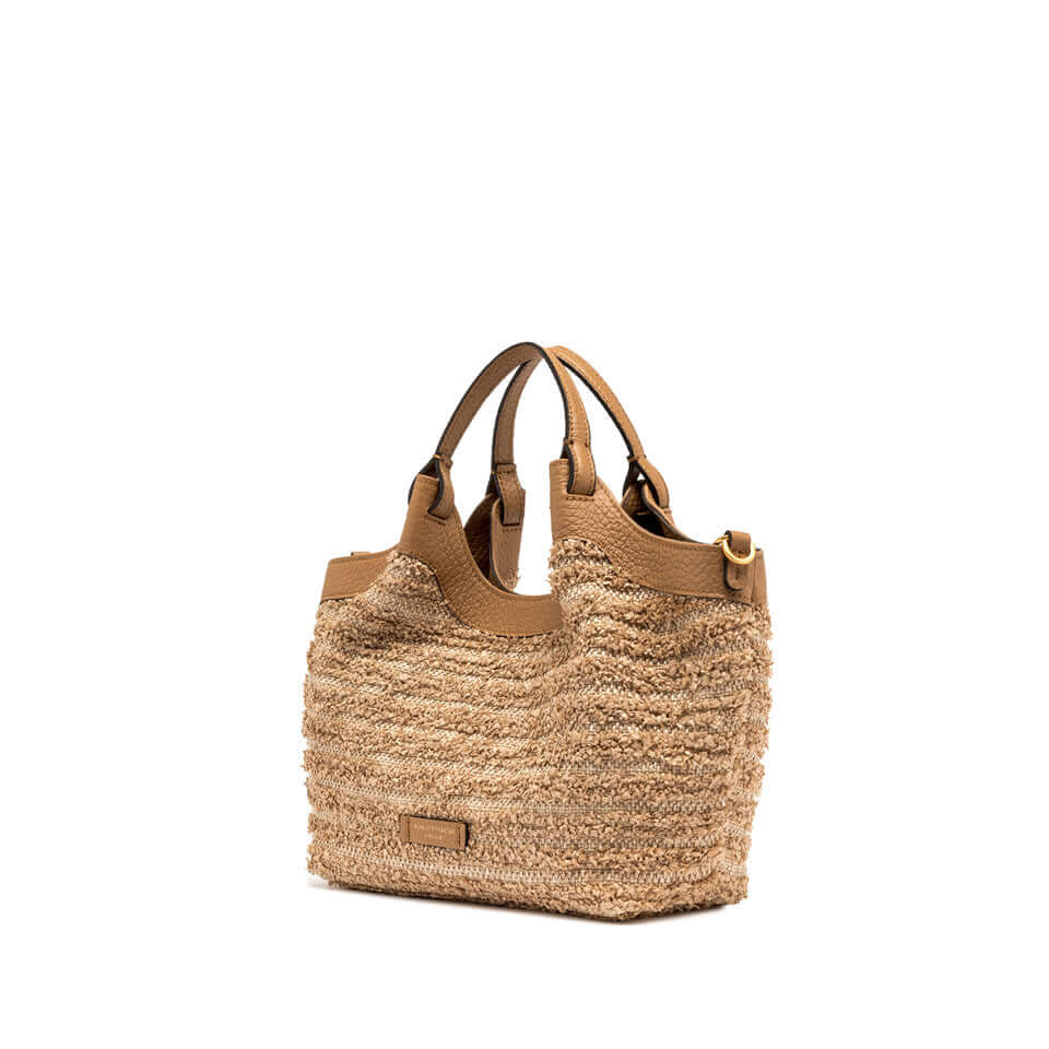 Versatile DUA straw handbag with leather handles, featuring a unique fru fru texture and dual carrying options.