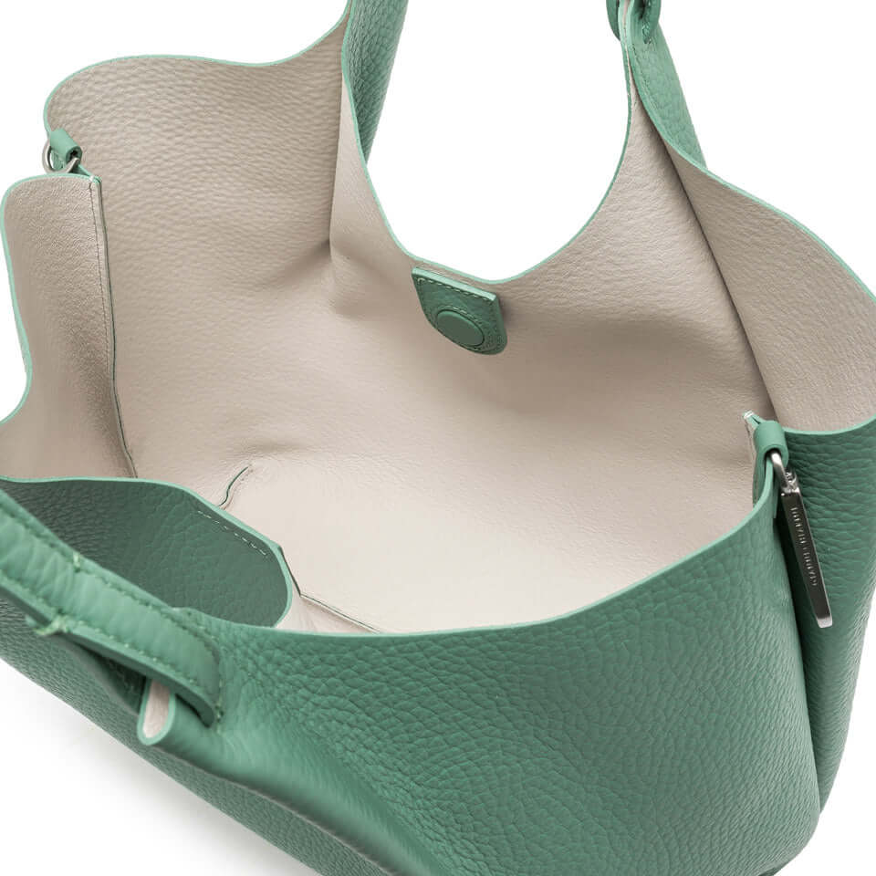 Inside view of the DUA bag featuring premium green leather and spacious design with dual handles.