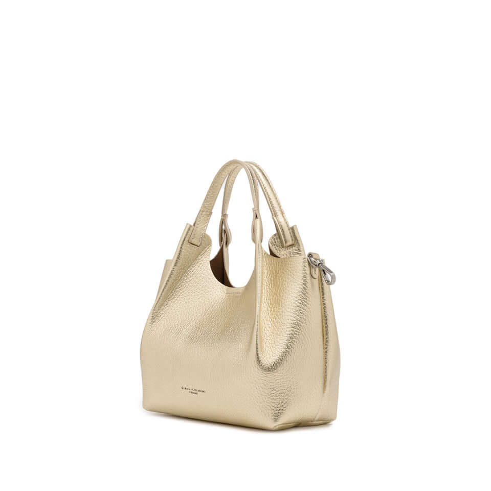 Elegant DUA handbag in metallic gold leather, perfect for enhancing any outfit, with dual handles and spacious design.