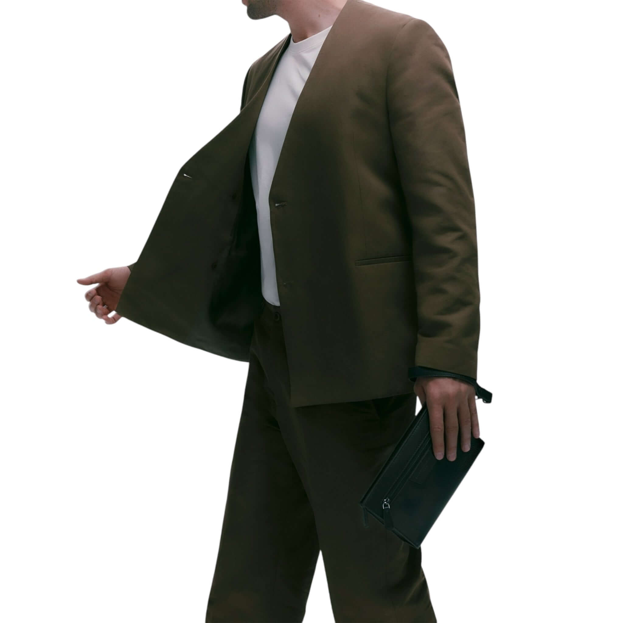 Man in brown suit holding a Florence clutch, showcasing modern style and minimal design for evening occasions.
