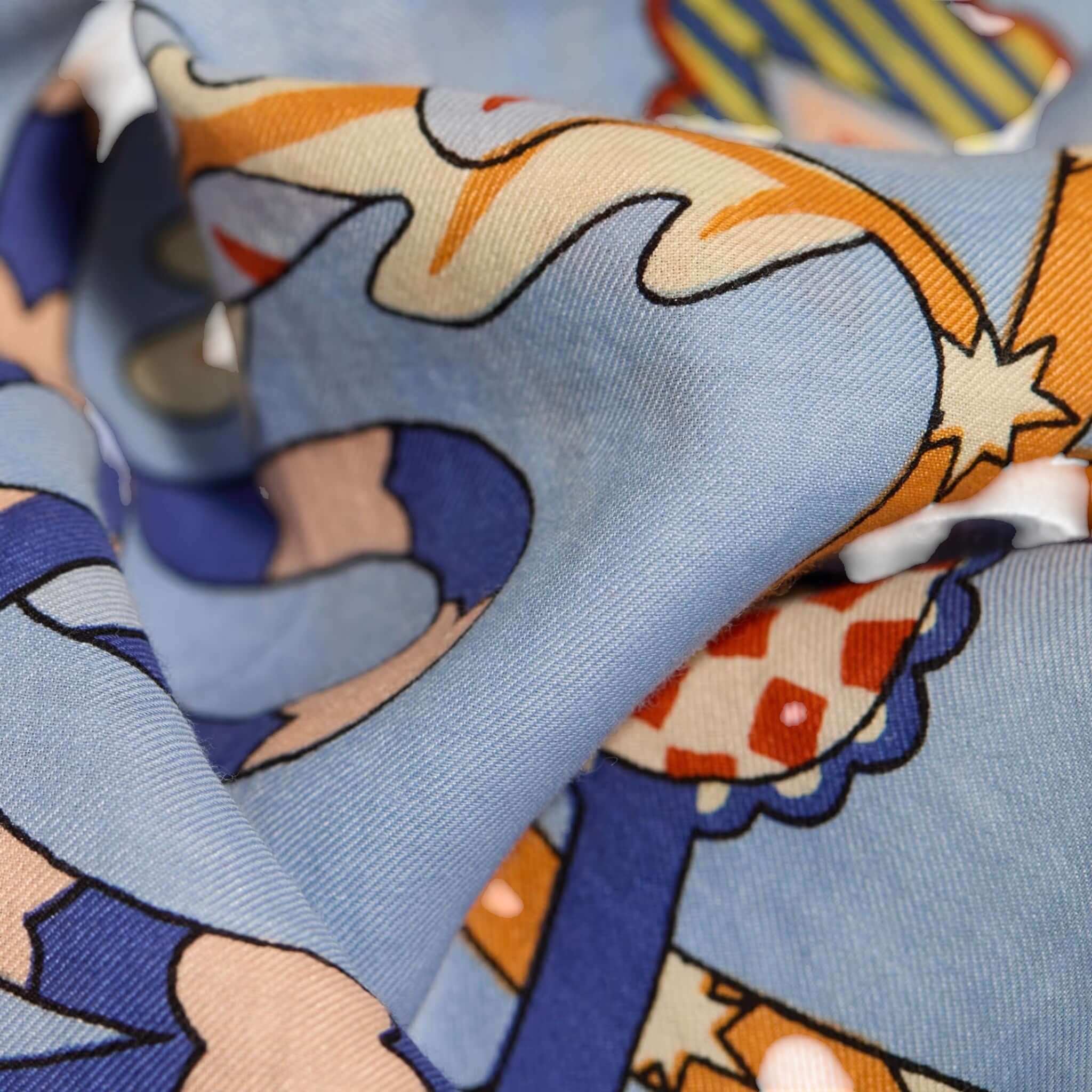 Close-up of Foulard Quadrato Botanique in vibrant colors, showcasing intricate hand-printed patterns on soft fabric.