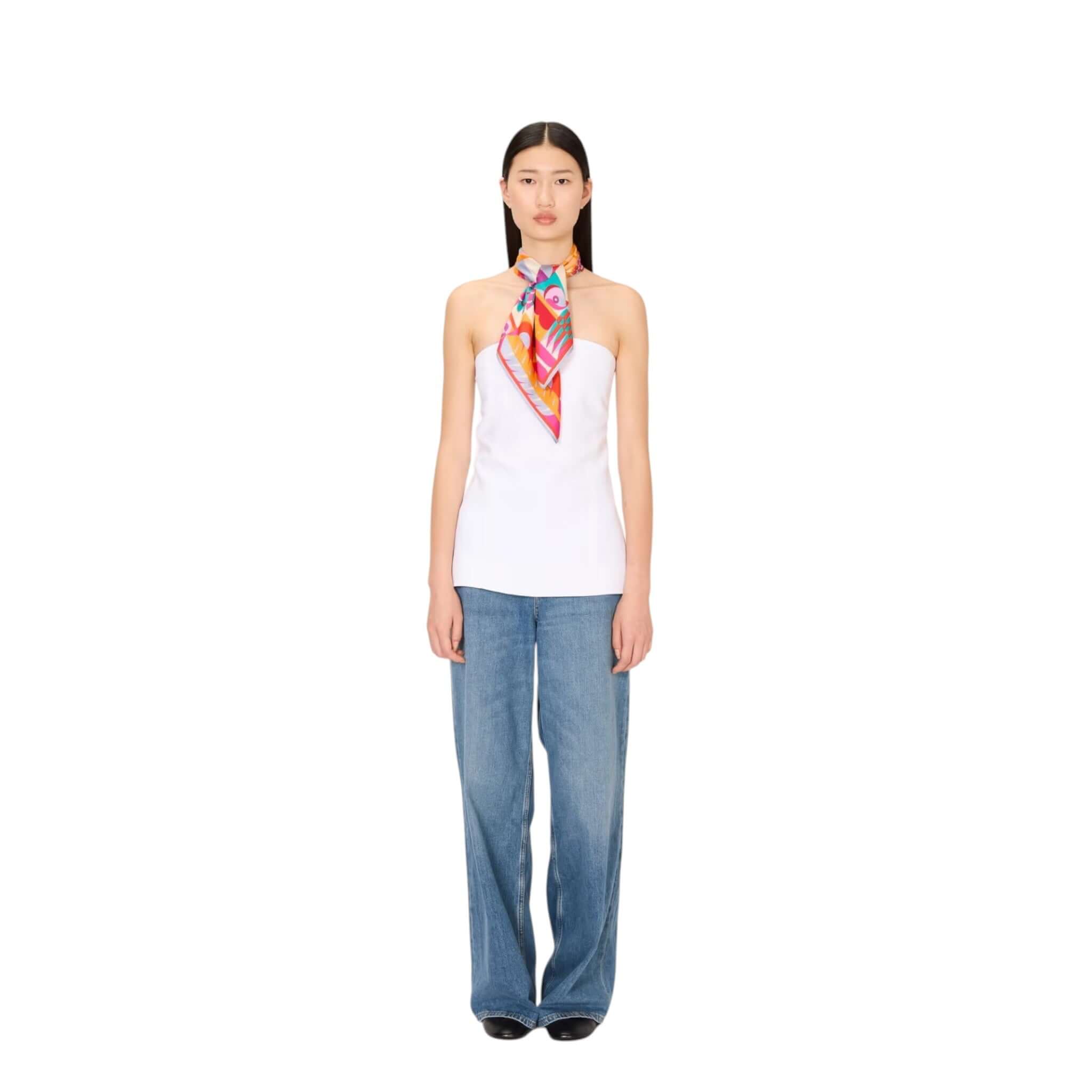 Model wearing a white top with Foulard Quadrato Cleo tied around the neck, styled with blue jeans.