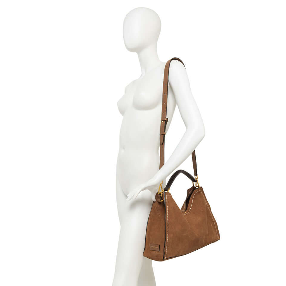 AURORA by Gianni Chiarini, trapezoidal brown suede handbag with adjustable strap, showcasing contemporary elegance.
