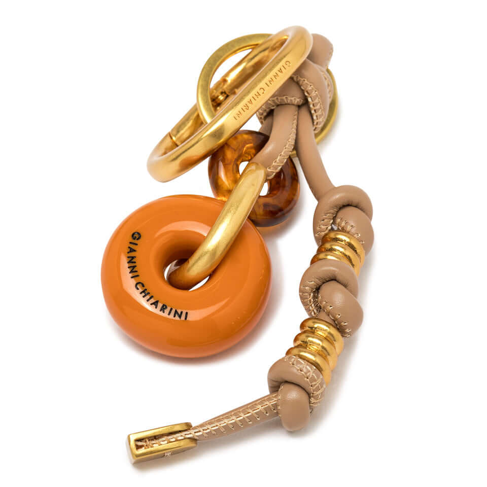 CHARM Resin Donut by Gianni Chiarini, decorative accessory for bags and backpacks, vibrant orange color.