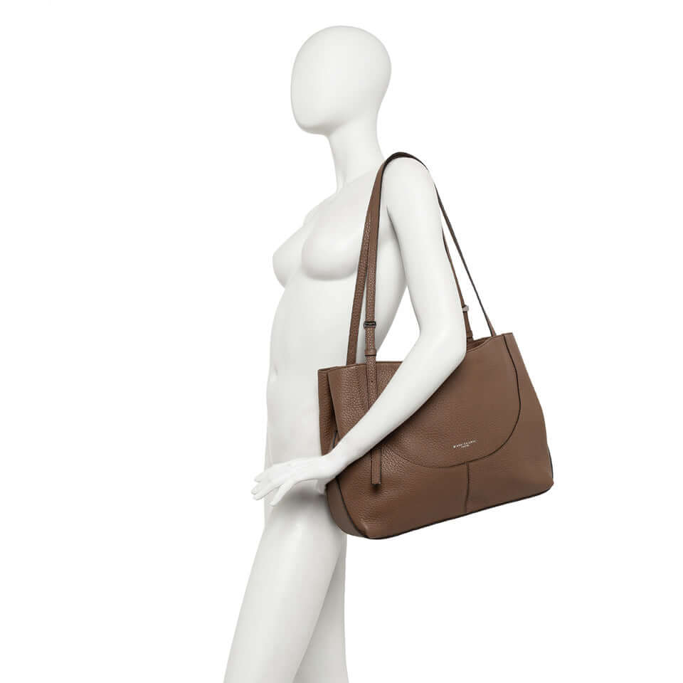 Minerva handbag by Gianni Chiarini in brown, featuring a clean design and two leather handles for easy shoulder carry.
