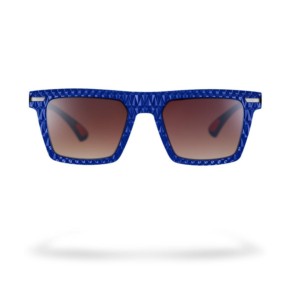 Occhiali da sole MICHI C3 con design moderno, montatura blu opaco e lenti marroni sfumate, collezione Flexo.