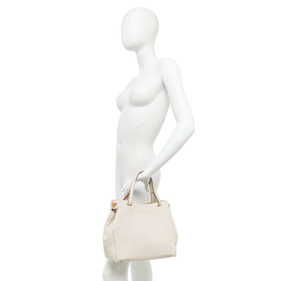 Woman's Ottavia bag by Gianni Chiarini Firenze in light beige, showcased on a mannequin, emphasizing its stylish design.