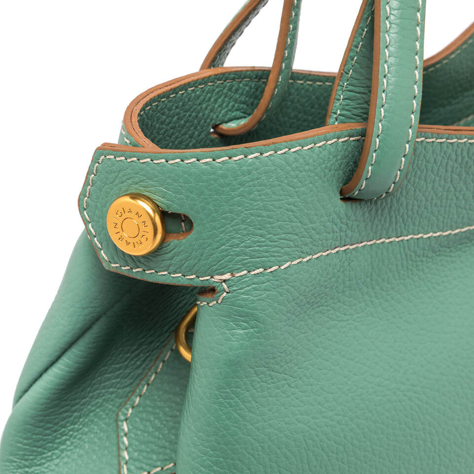 Close-up of the Ottavia by Gianni Chiarini Firenze handbag, showcasing the green pebbled leather and gold logo button detail.