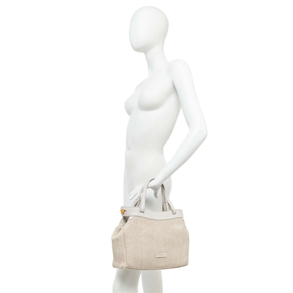 Ottavia by Gianni Chiarini, woven straw bag held by mannequin, stylish and versatile for daily use.