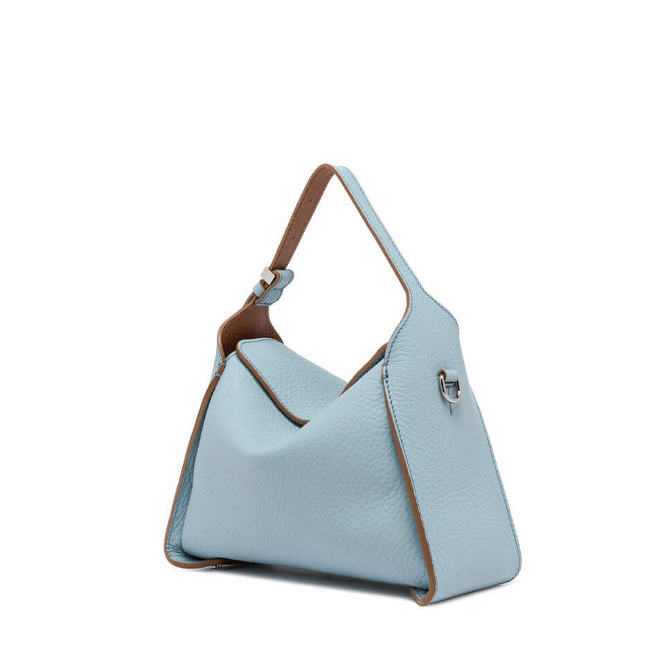 Side view of Penelope handbag in soft blue leather with brown accents and adjustable strap.