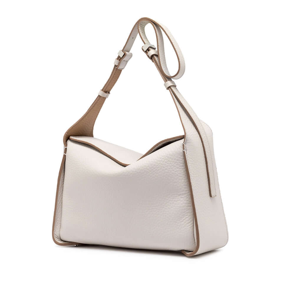 Stylish white leather handbag 'Penelope' with adjustable strap and unique box architecture.
