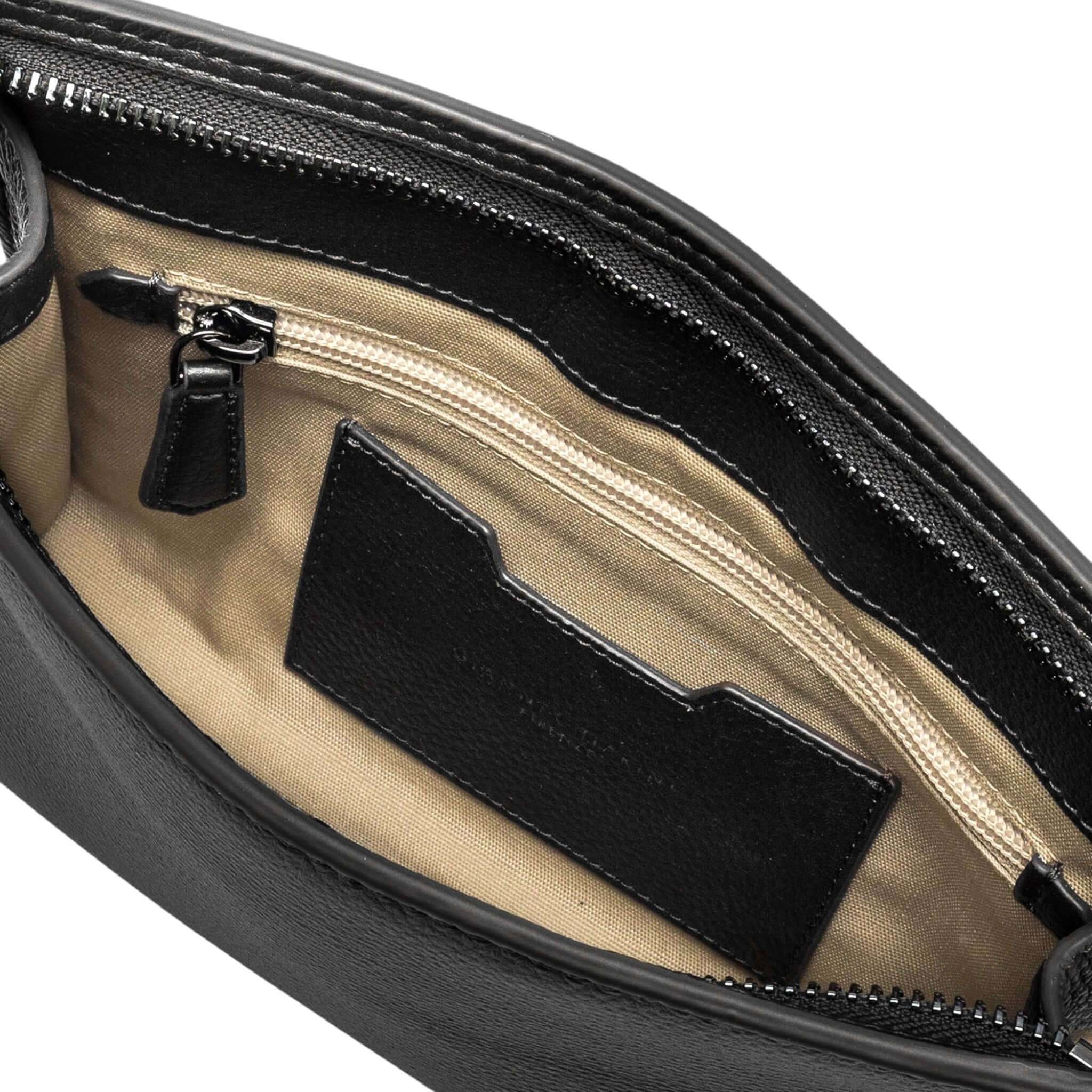 Inside view of the Florence pochette, showcasing main zip compartment and leather card slot.