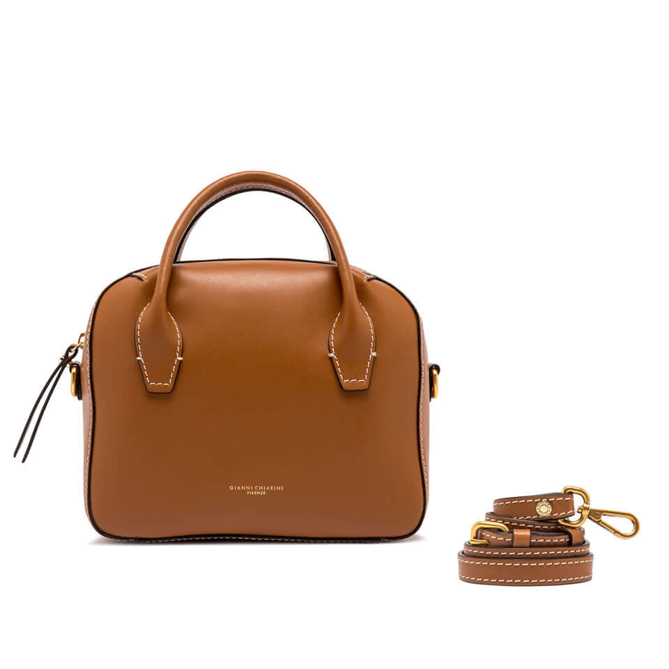 Sabrina bowling bag in smooth brown leather with double handles and a detachable strap, compact and stylish for daytime use.