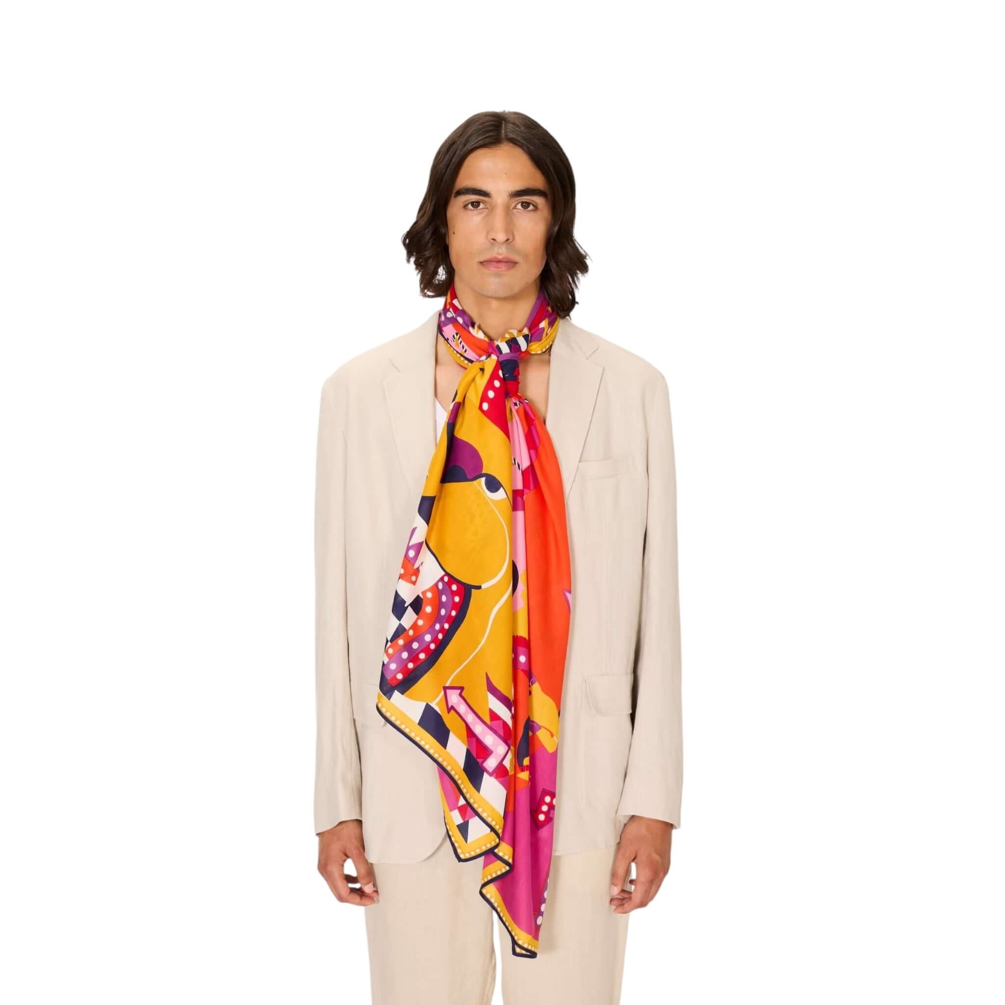 Model wearing the Sciarpa Rollercoaster scarf in vibrant colors against a neutral suit, showcasing its unique handmade print.