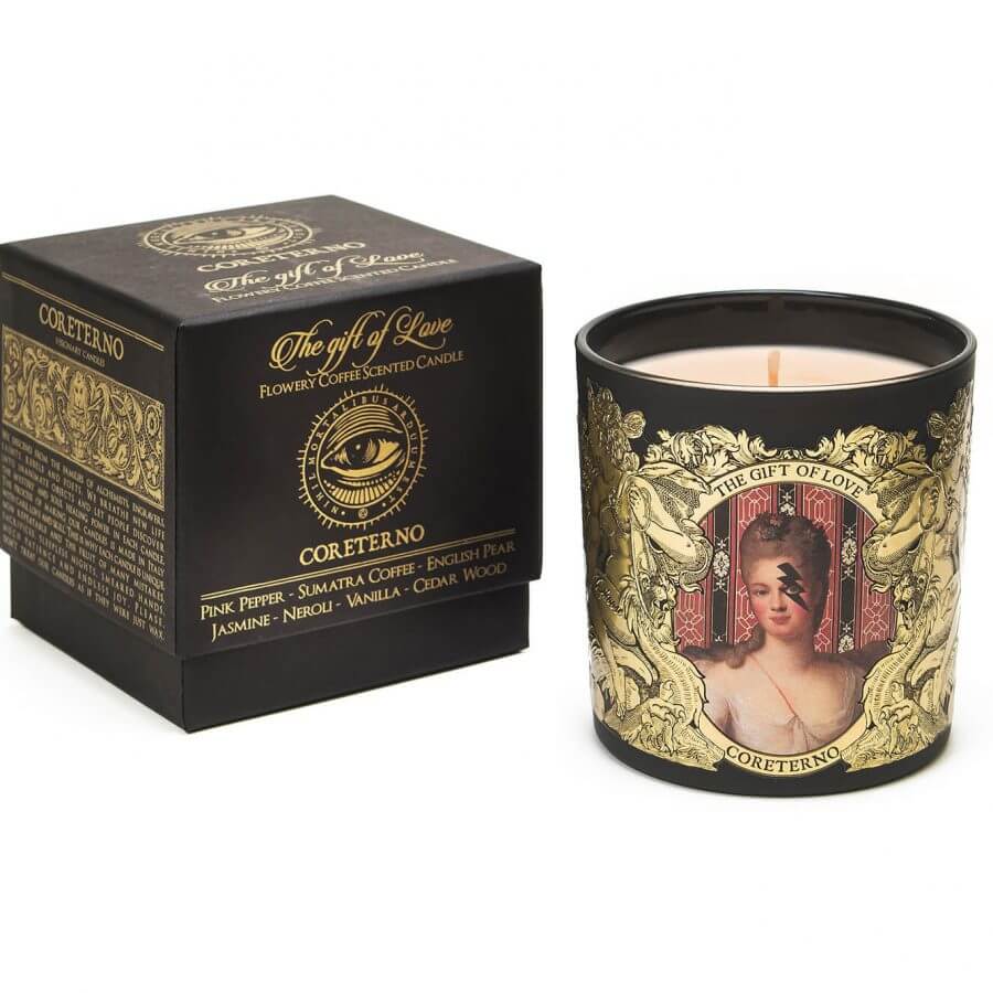 The Gift of Love scented candle with ornate packaging featuring floral and coffee scents.