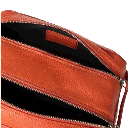 Detail of Beauty Case Micron in Pelle showing interior compartments and zip closures, made in Italy, in orange leather.