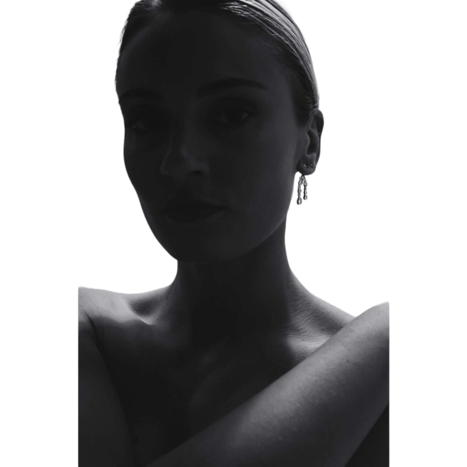 Silhouette of a woman wearing stylish earrings, showcasing elegance and sophistication.