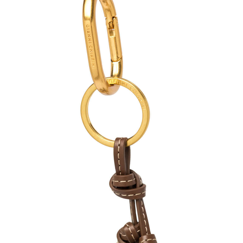 CHARM Gianni Chiarini Firenze in pelle sintetica con moschettone logato e dettagli annodati per accessori moda.